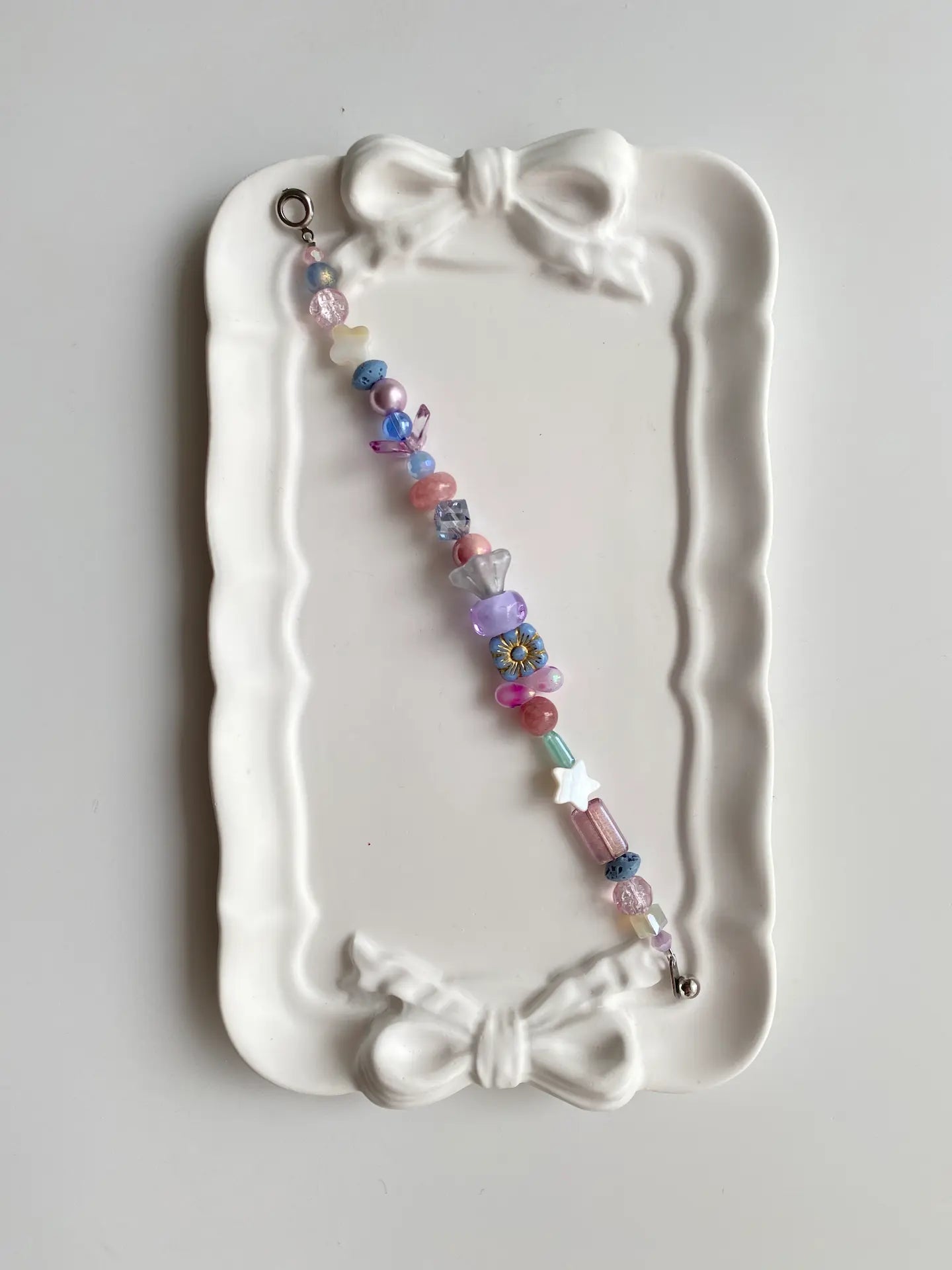 Fresh blue beaded bracelet with clover shell charms and rectangular accents.