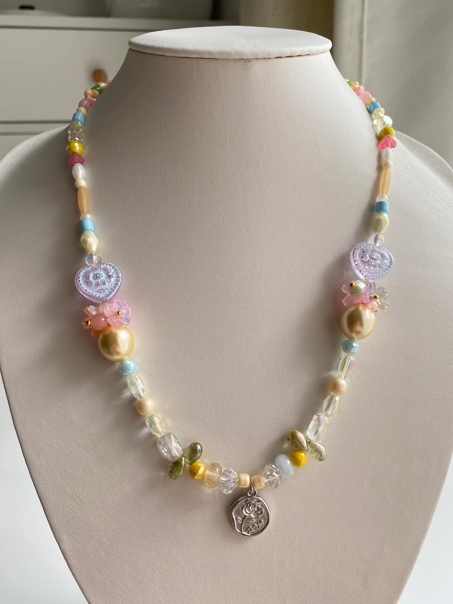 HuibenCraft 1-of-1 handmade necklace with symmetric hand-assembled glass flowers and rose pendant on a mannequin.