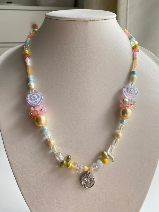 HuibenCraft 1-of-1 handmade necklace with symmetric hand-assembled glass flowers and rose pendant on a mannequin.