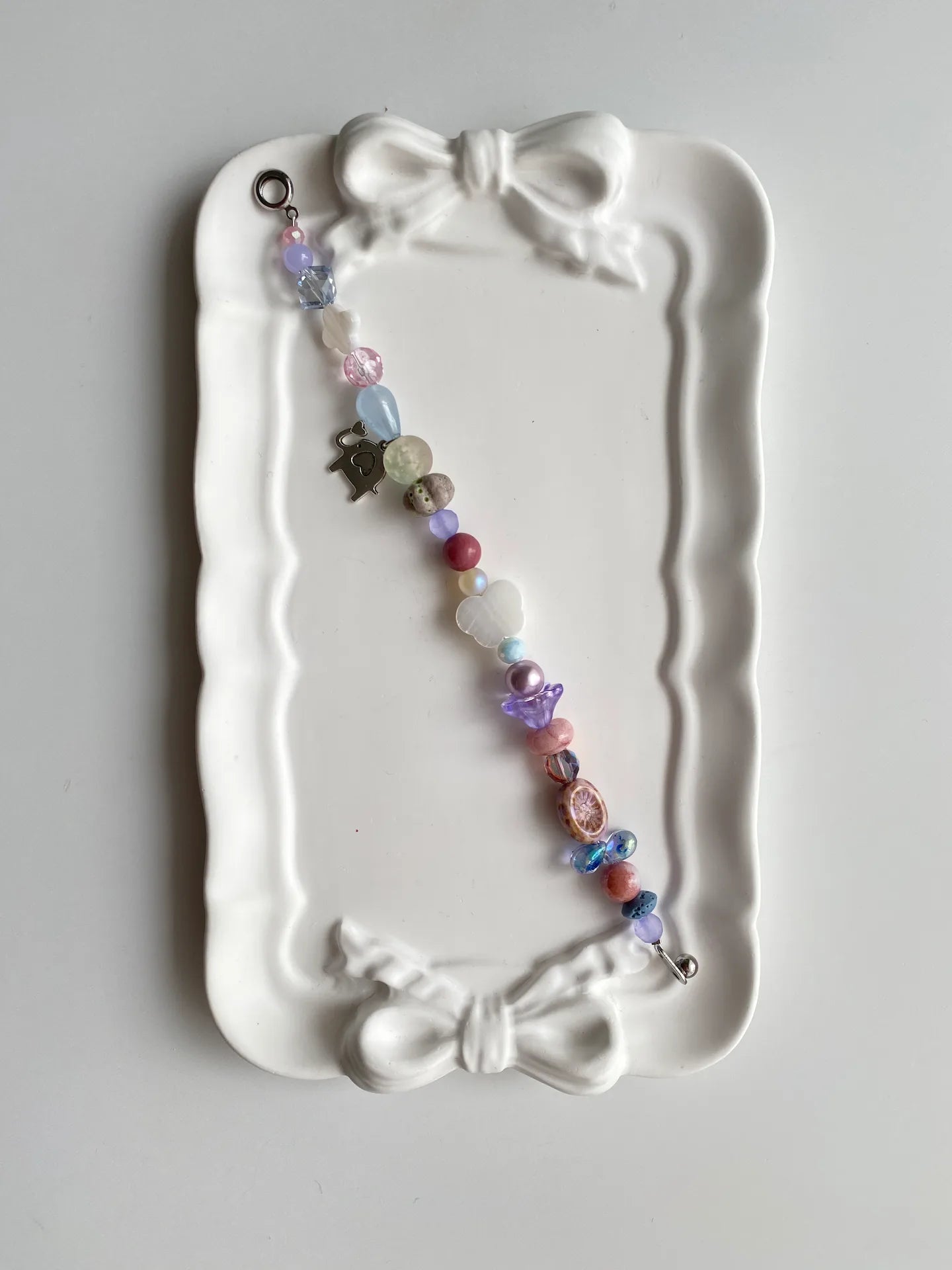Gentle butterfly shell bracelet with pearlescent beads and soft pastel tones.