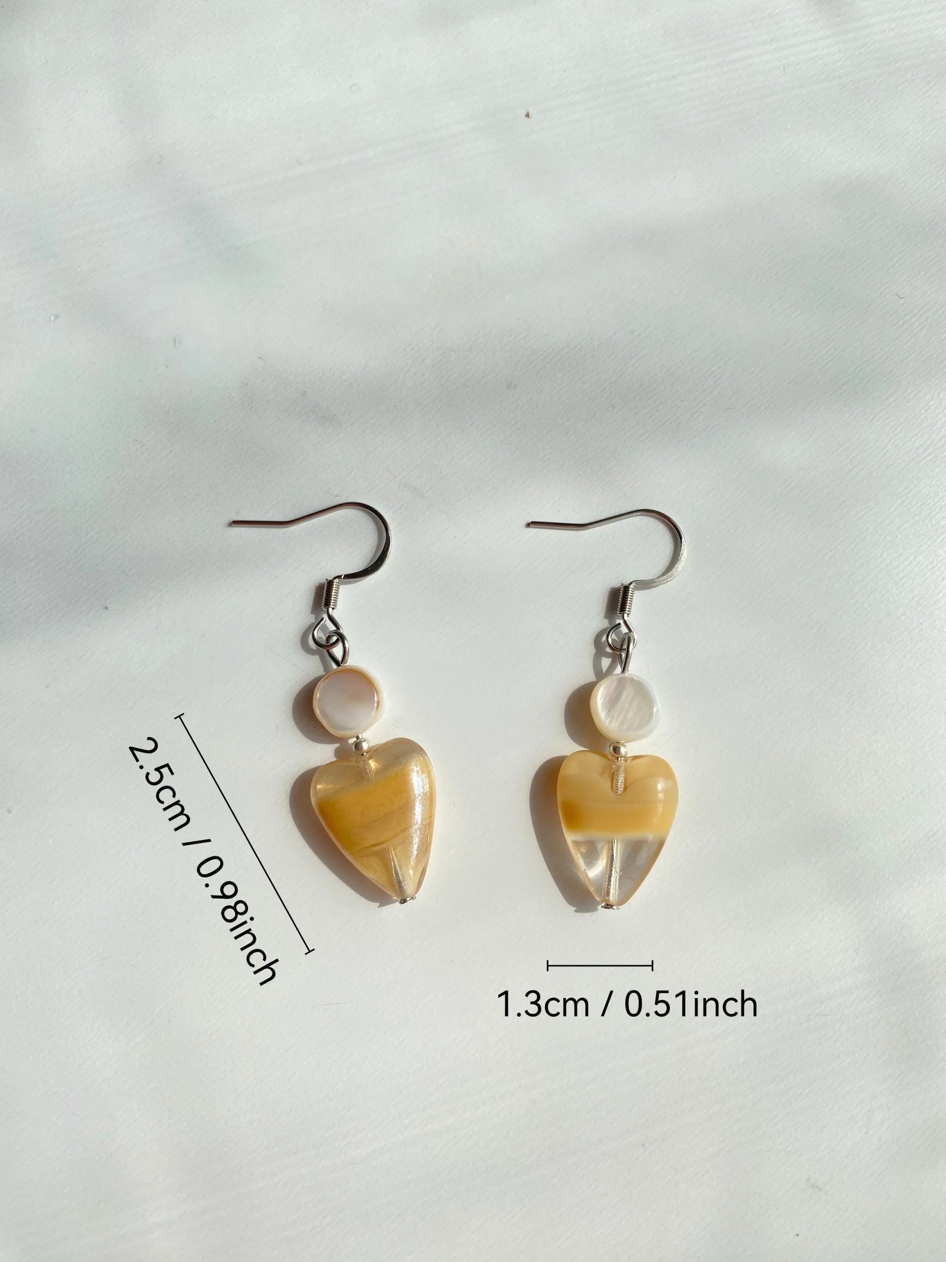 Size measurement in inches of the light coffee heart and natural shell earrings with stainless steel hooks.