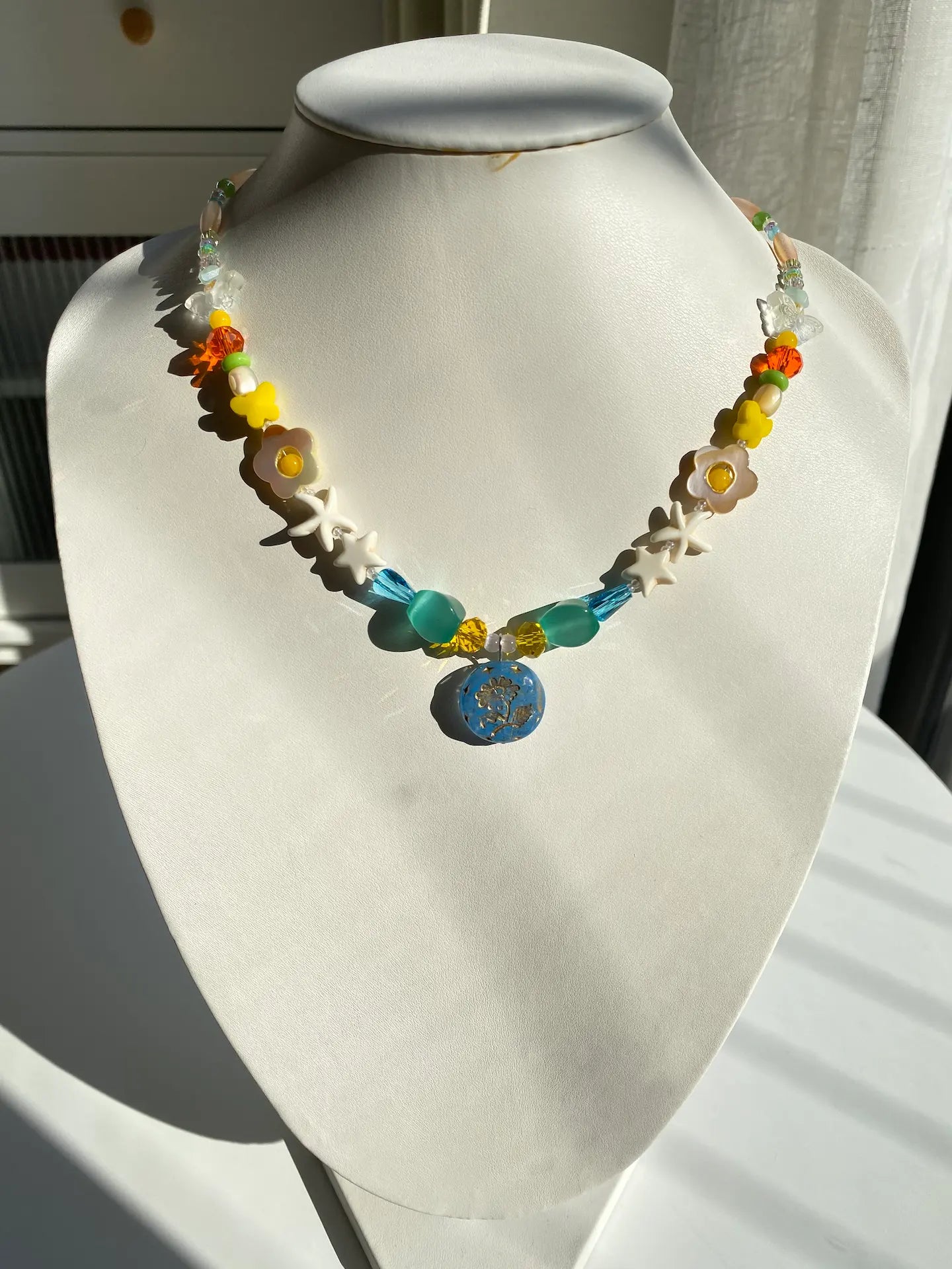 The 1-of-1 Margaret flower necklace displayed on a mannequin, showing its elegant drape and 17.13-inch length.