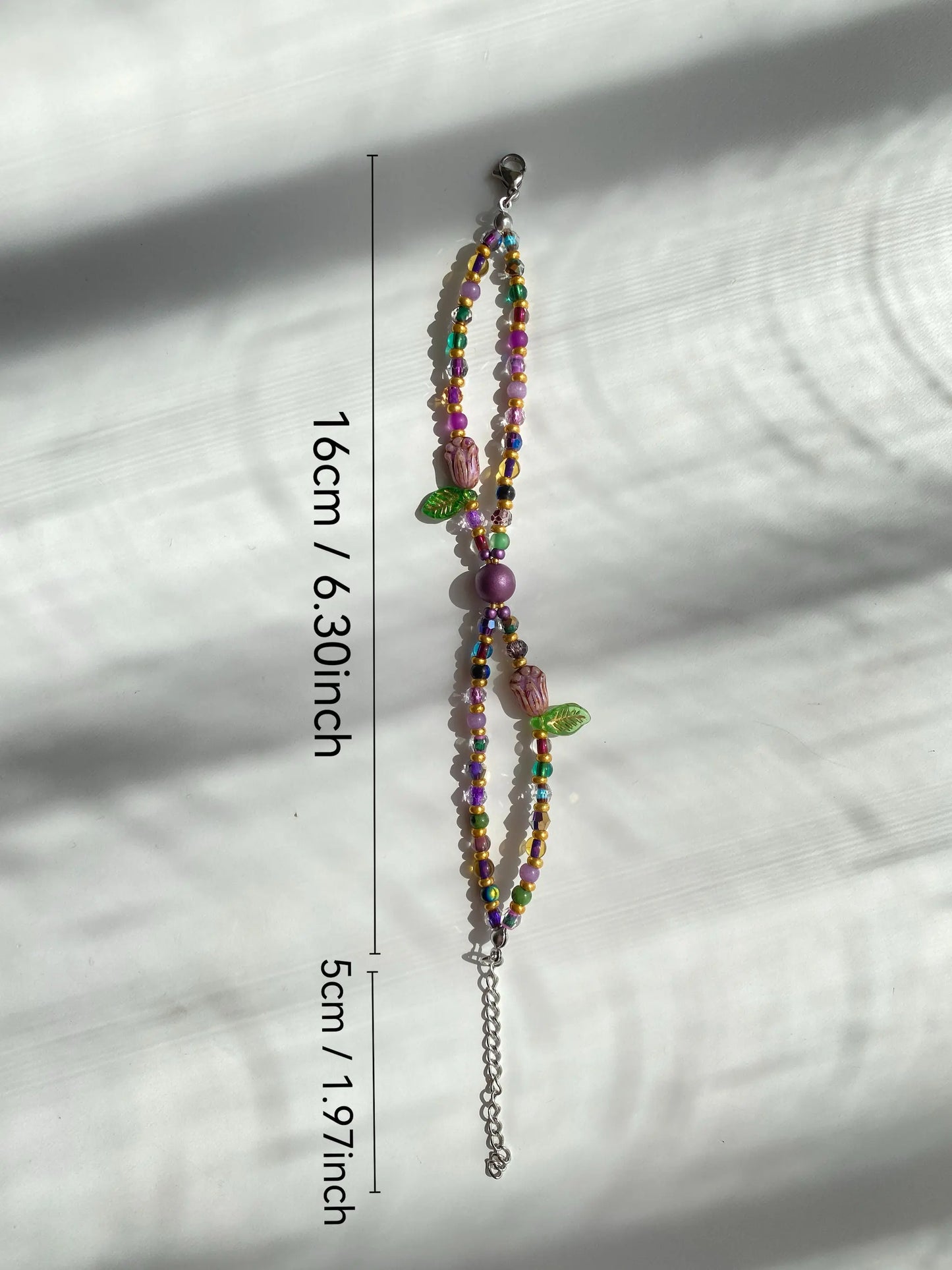 HuibenCraft 1-of-1 faux pearl and purple glass double-layered bracelet with golden spacers in soft sun shadows.