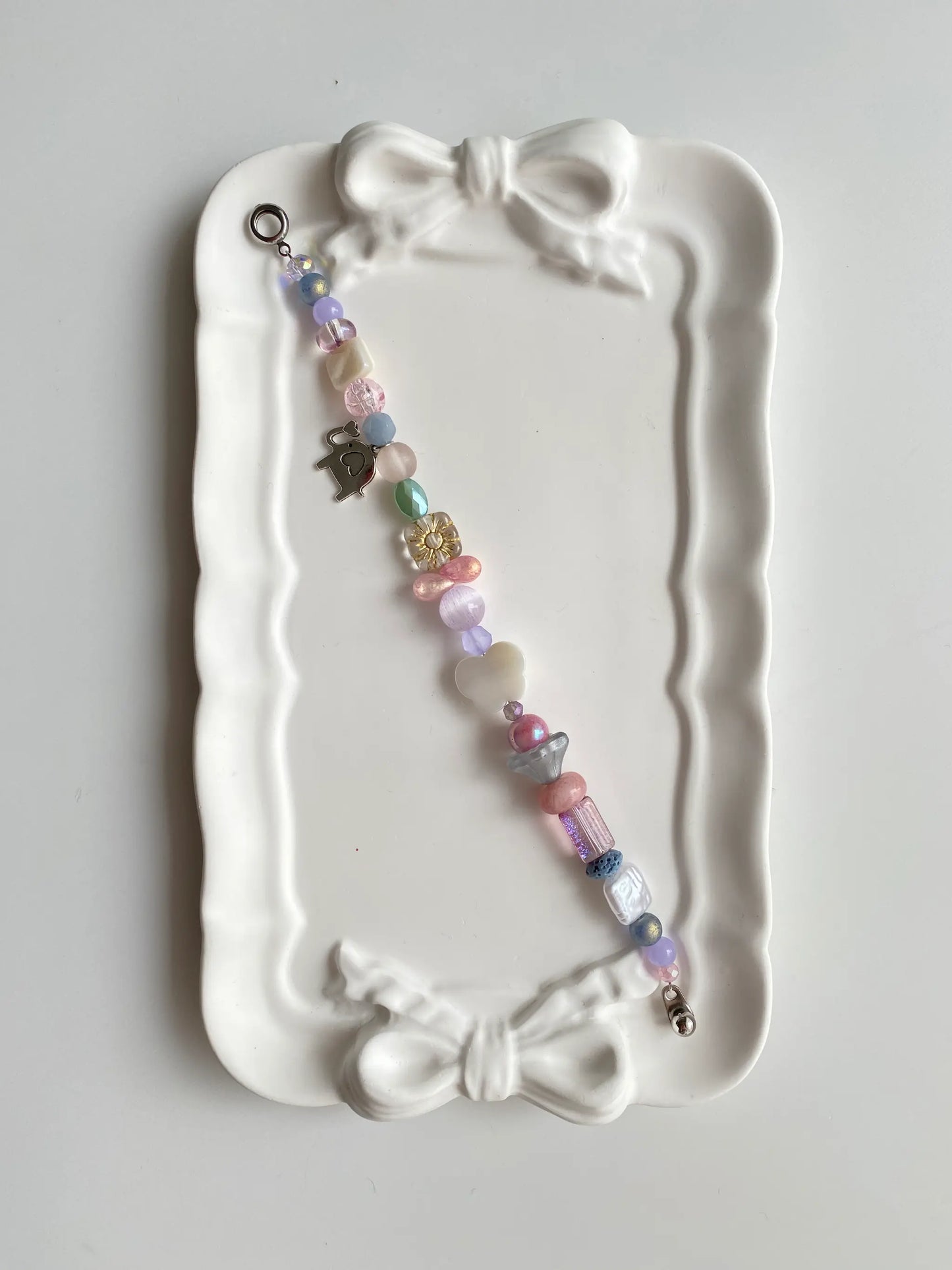 Romantic pink and purple beaded bracelet with butterfly shell and floral beads.