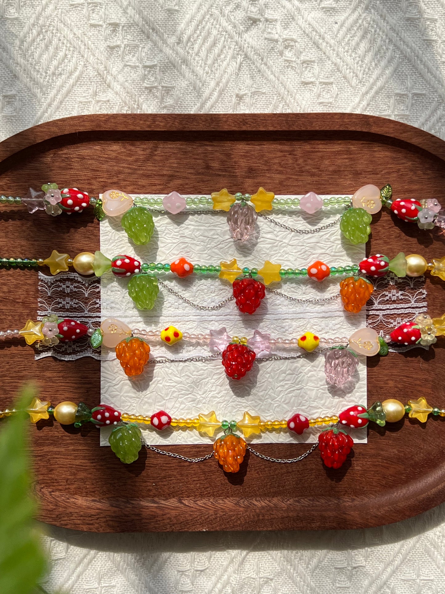 Glass flower accents with flower caps and pearl-shaped beads on the necklace collection.