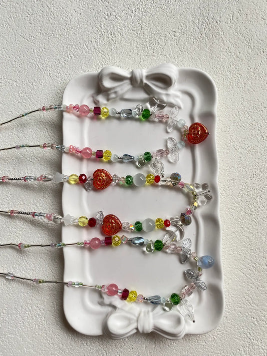 HuibenCraft trio of 1-of-1 vibrant colorful seed bead necklaces arranged as a flat lay in a plate, top-down view highlighting a bright, beach-ready aesthetic.