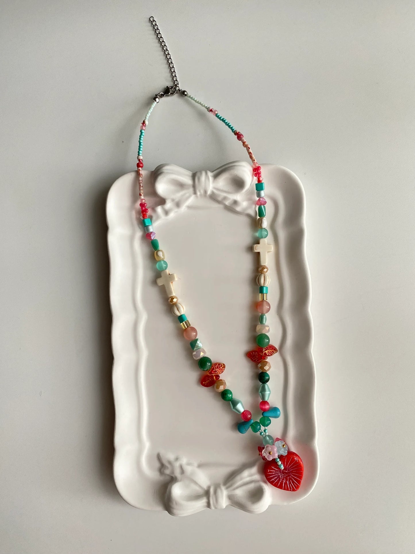 HuibenCraft 1-of-1 vintage-style red heart necklace with floral clusters in a white ceramic dish, a perfect gift for joy and positive vibes.